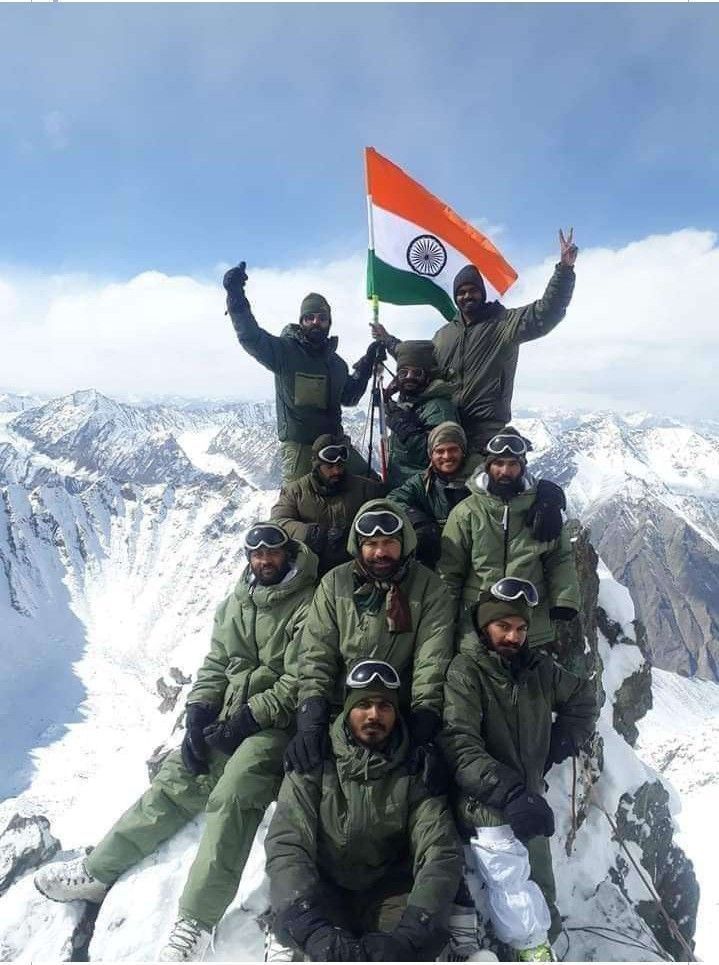 Indian Army soldiers on mountain with flag